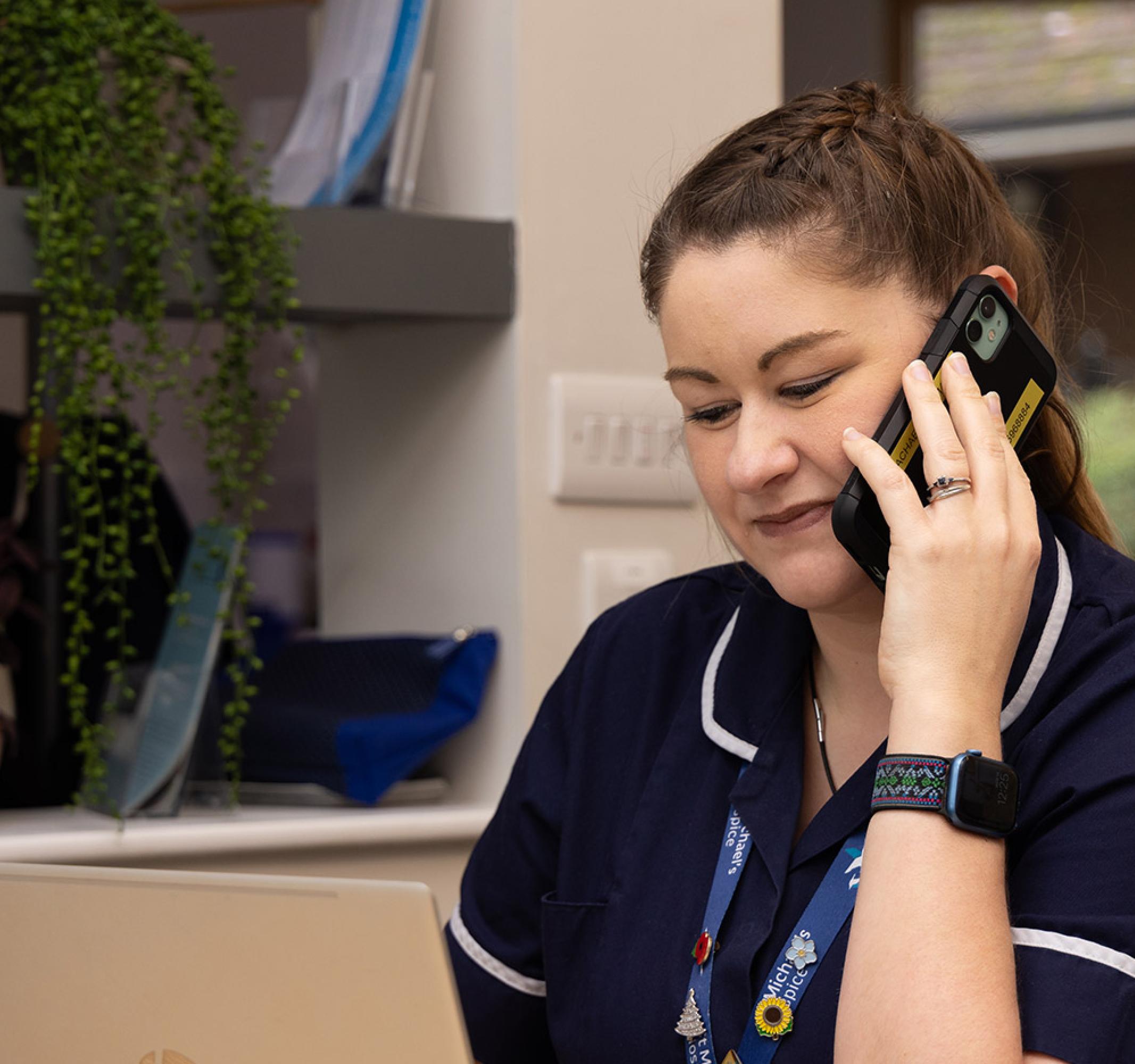 Care team at desk on laptop using a telephone