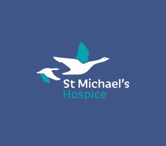 St Michael's Hospice logo: two stylized flying birds, one white, one teal.