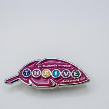Pink leaf-shaped enamel pin for St. Michael's Hospital THRIVE volunteers.
