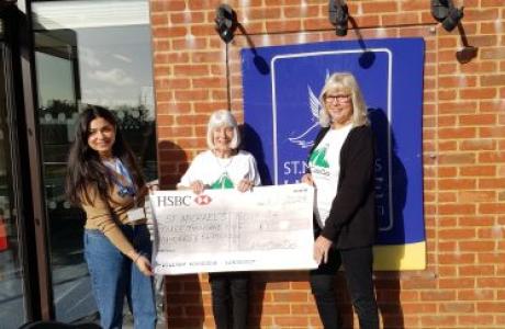 3 women presenting a cheque