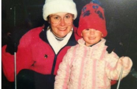 Lucy as a child with mum ruth both smiling wearing woolly hats