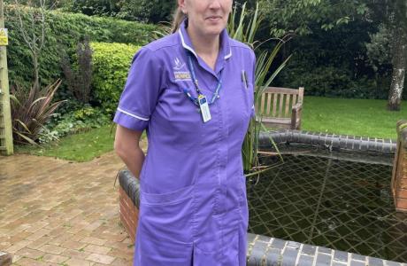 Anne standing outside the hospice wearing her Nurse uniform