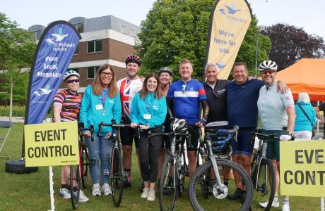 Group of cyclists standing by their bikes having completed the challenge