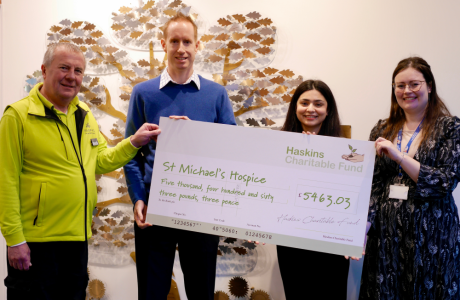 Four people presenting a cheque for £5463.03