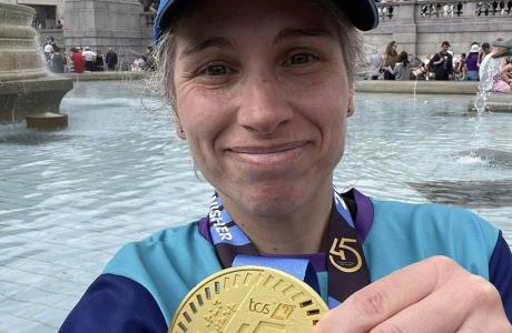 Lisa holding her medal smiling proudly at the camera after the London Marathon