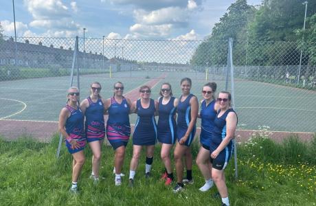 netball team standing outside of a netball court