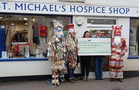 Overton Mummers presenting a cheque to us outside our shop in Overton.