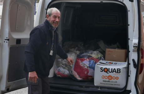 Roger volunteering at the hospice by unloading a van of supplies