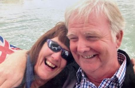 Lady and man leaning together laughing