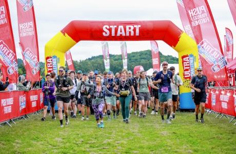 Photograph of a crowd of people running out of the North Norfolk Ultra Challenge startling