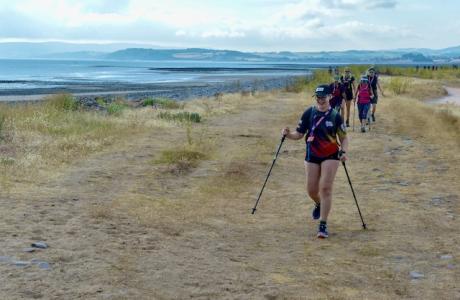 People hiking with the sea in the background