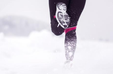 Photograph of a runner running on a snowy day