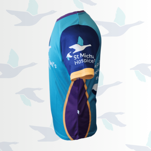 Turquoise and purple sports jersey, side view, with "St Michael's Hospice" logo on sleeve.