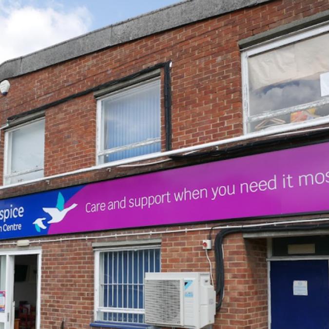 St Michael's Hospice brick building with a purple sign and white bird logo.