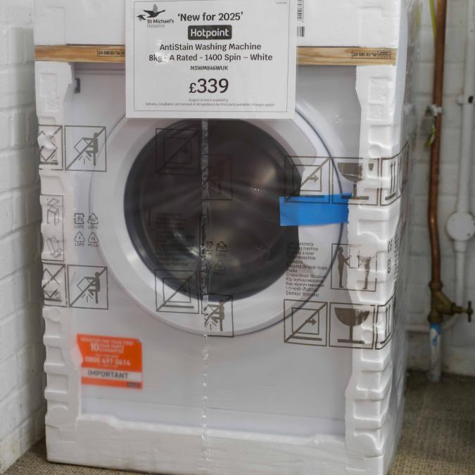 New white washing machine in foam packaging, with a £339 price tag.