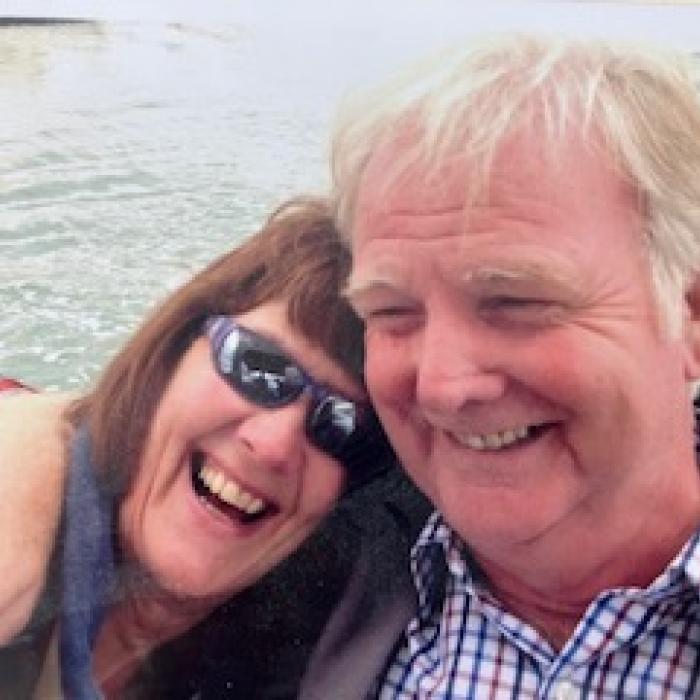 Lady and man leaning together laughing