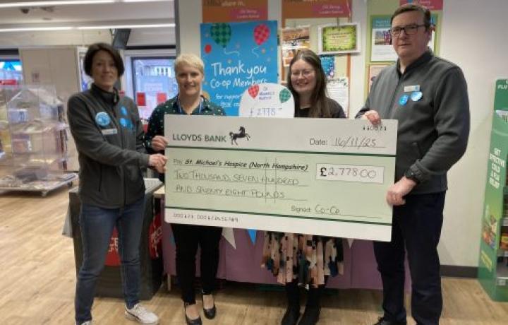 Four people present a large check for €2,775.00 to St Michael's House.