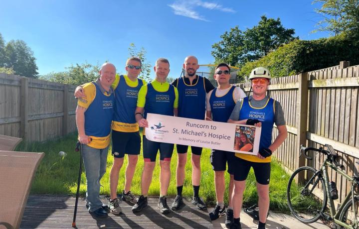 6 cyclists with a cheque 
