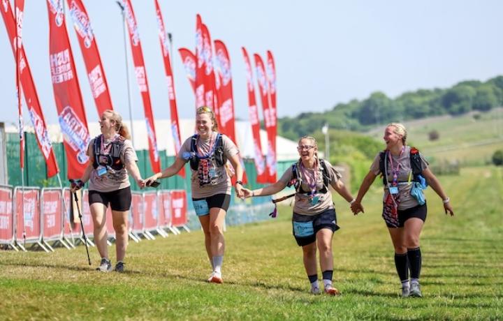 A group of 4 people are golding hands while taking part in the ultra challenge