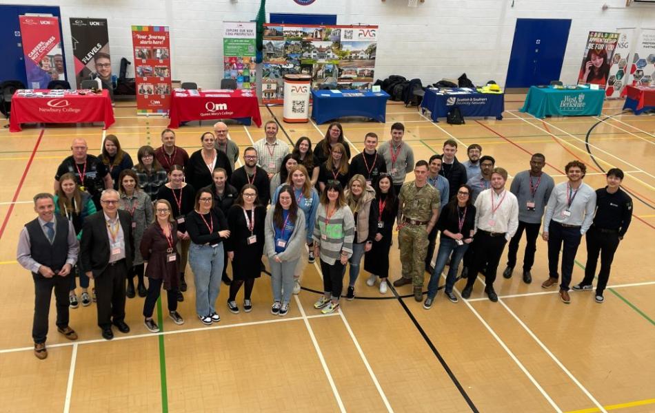 group of teachers in school sports hall at careers day