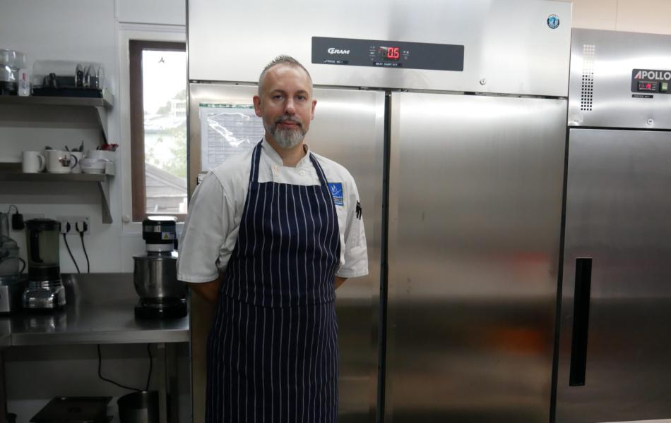 Chef standing in a professional kitchen.