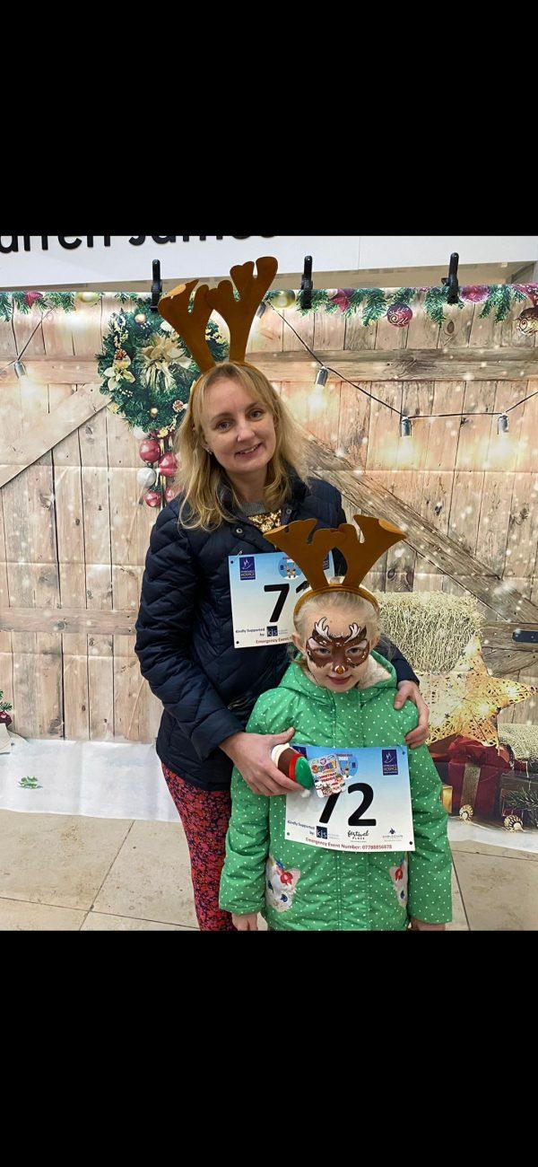 Charlotte and her daughter taking part in the Reindeer Run wearing Reindeer antlers and face paint