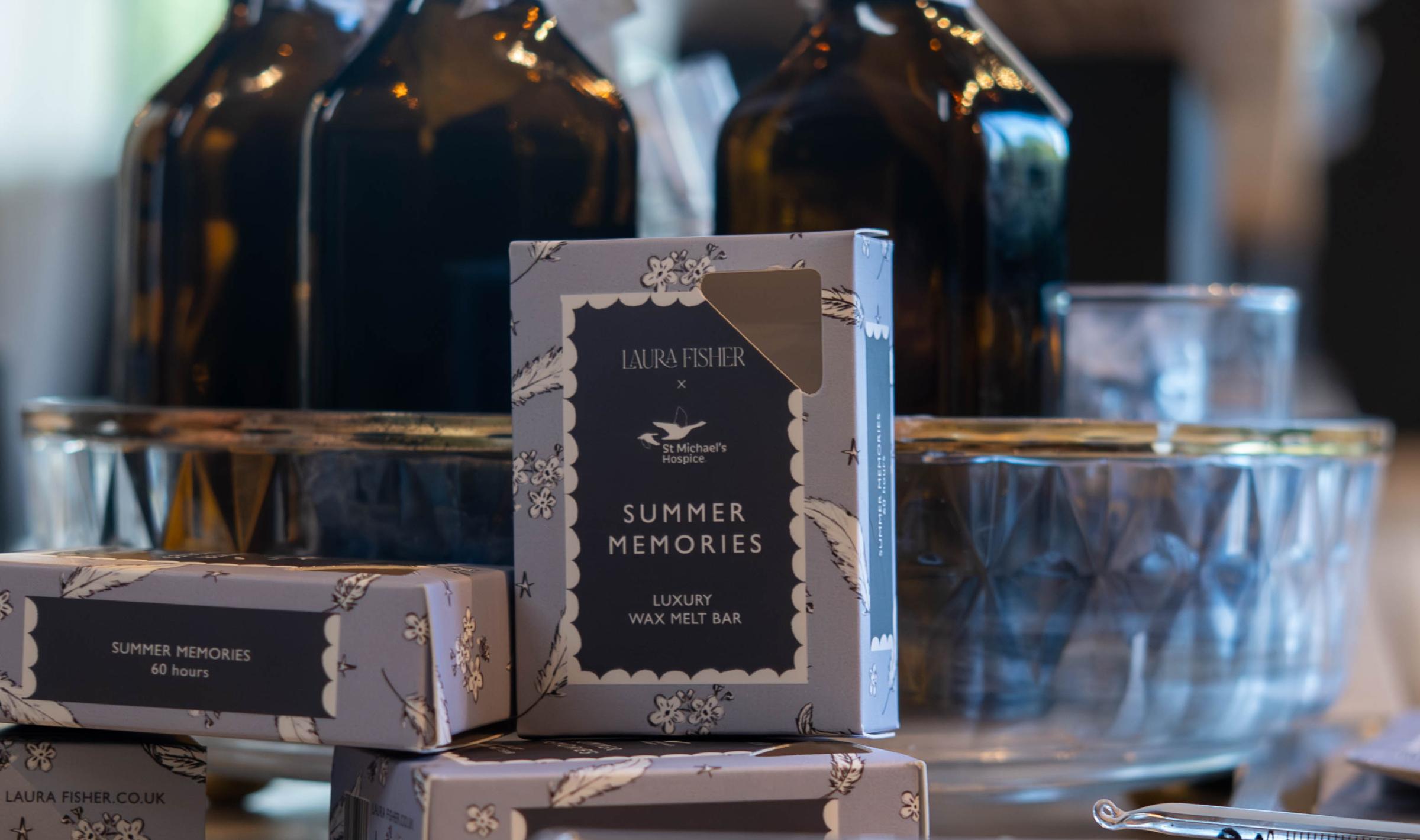 Beauty product display with dark bottles, packaged soaps, and clear samples.