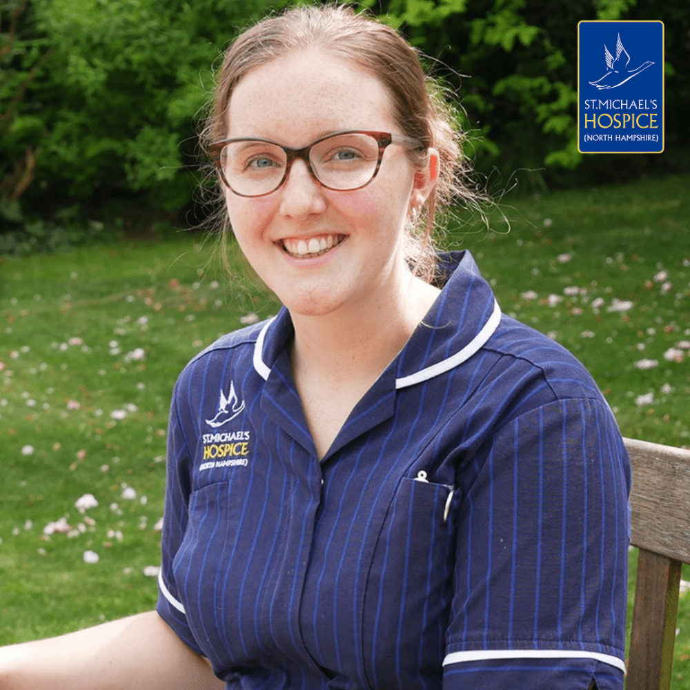 Image of Nurse Ellie sat on a bench smiling at the camera