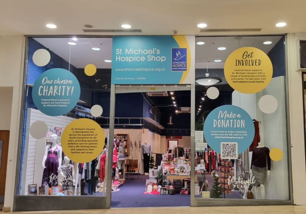 Image of the pop up shop in Festival Place with St. Michael's Hospice green and yellow branding