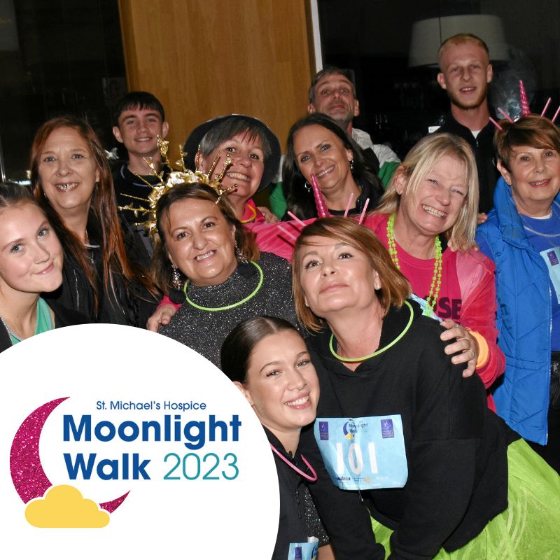 Image of a group of people taking part in Moonlight Walk all smiling at the camera as a group