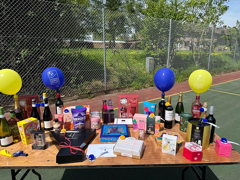 Image of the netball team's raffle, with St. Michael's Hospice balloons