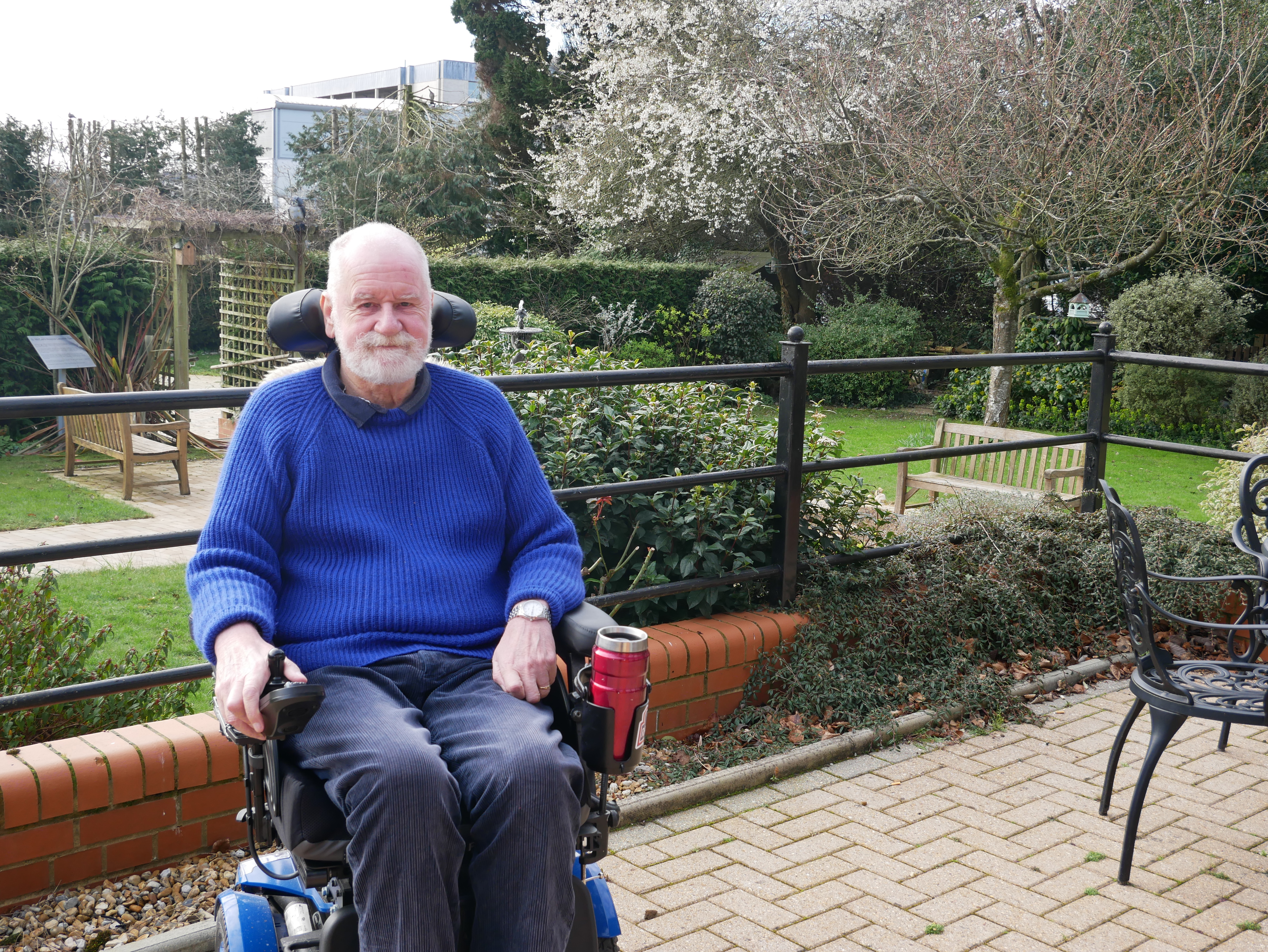 Simon smiling the camera. The Hospice gardens are behind him.