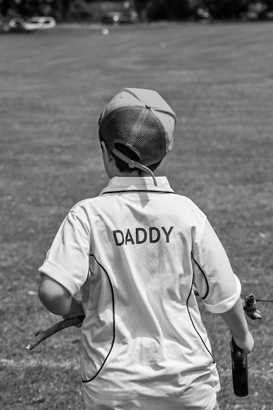 Image of a child wearing a top that says 'Daddy' on the back