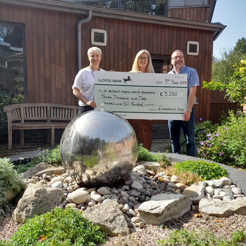 Group of people from the Golf Day presenting us with a giant cheque