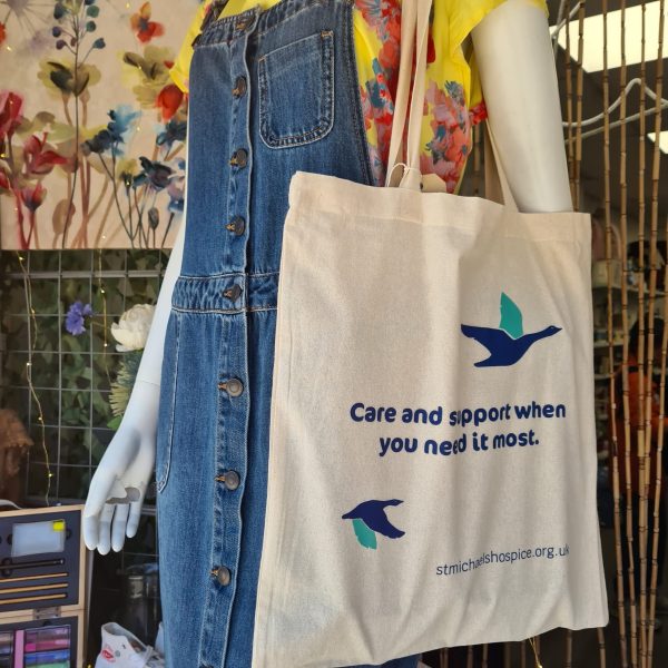 Image of a manakin wearing the tote bag