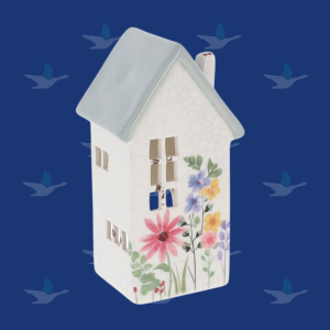Photograph of a decorative ceramic tea light holder in the shape of a house